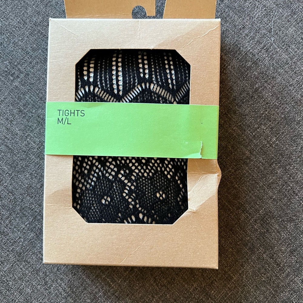 Black crocheted tights. Fishnet like with floral motif.